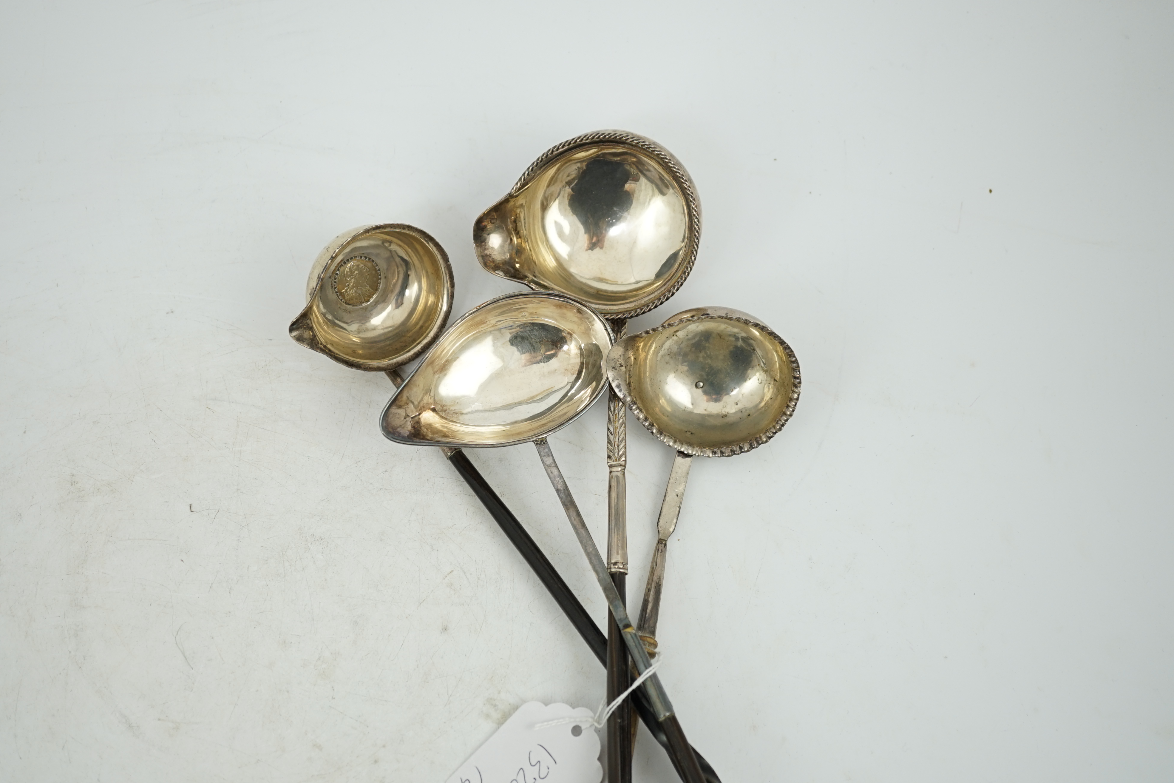 A Georgian silver toddy ladle, makers mark stamped four times (rubbed), 43cm and three other unmarked toddy ladles.